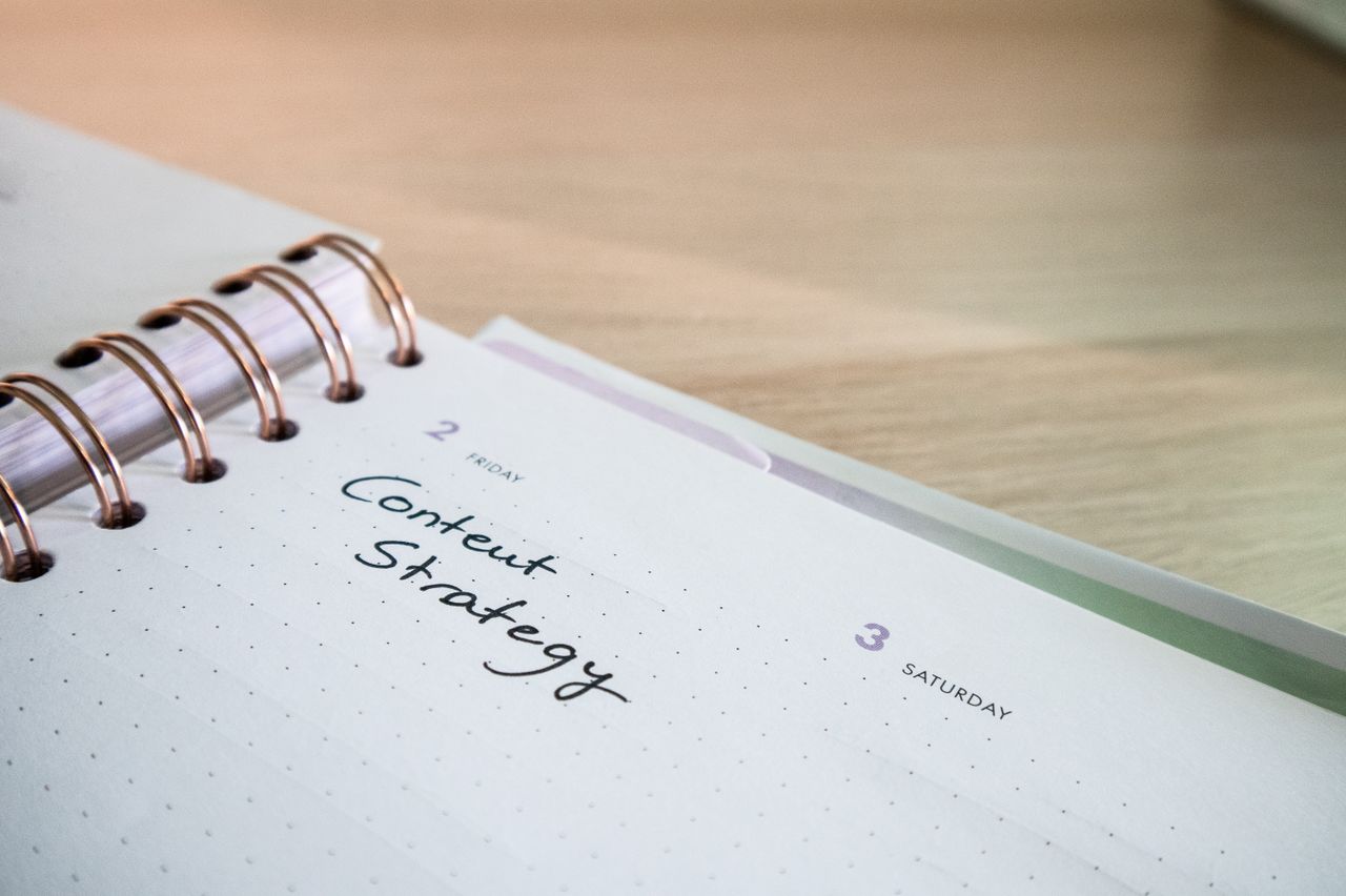 Close-up view of a notebook page showing Content Strategy written on it, ideal for business planning visuals.